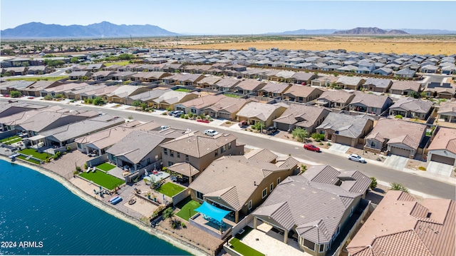 drone / aerial view with a water and mountain view