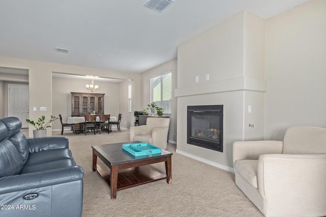 living room featuring light colored carpet and a chandelier