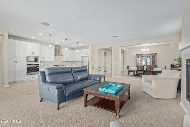 living room with light carpet and a notable chandelier