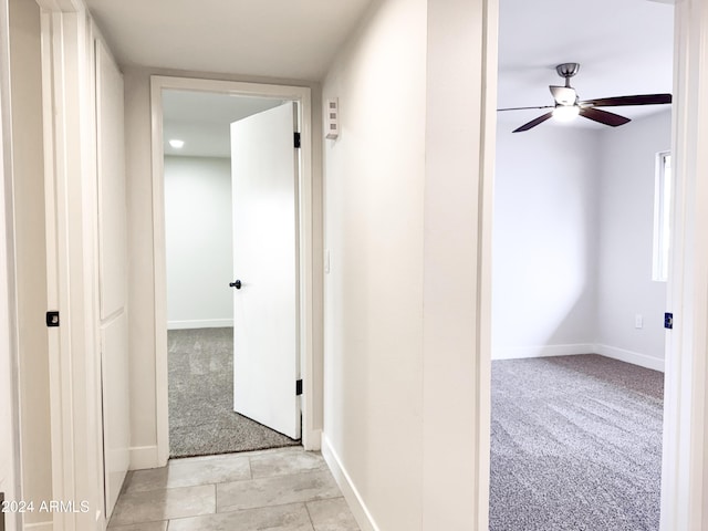 hallway with light colored carpet