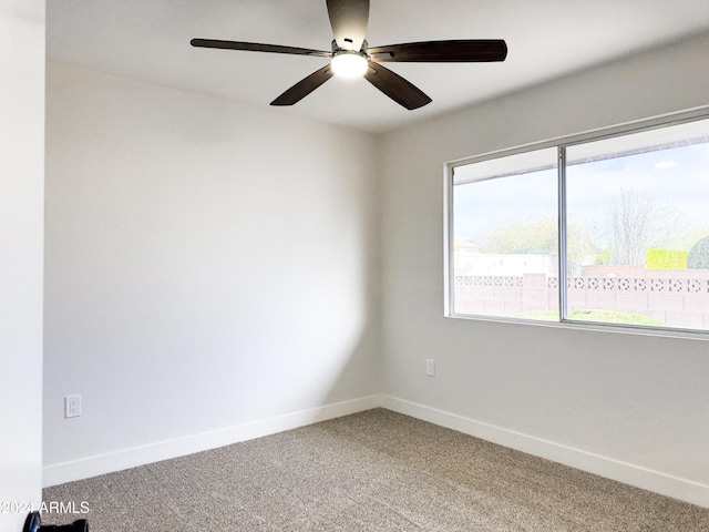 empty room with ceiling fan and carpet floors