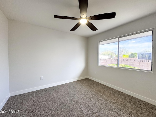 spare room featuring carpet flooring and ceiling fan