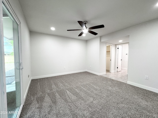 carpeted spare room with ceiling fan