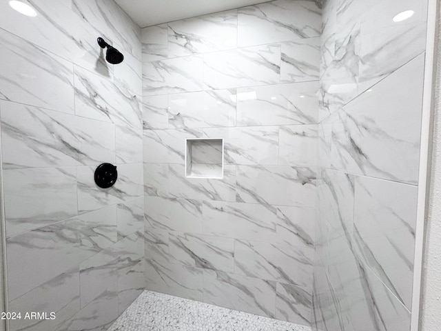 bathroom with a tile shower