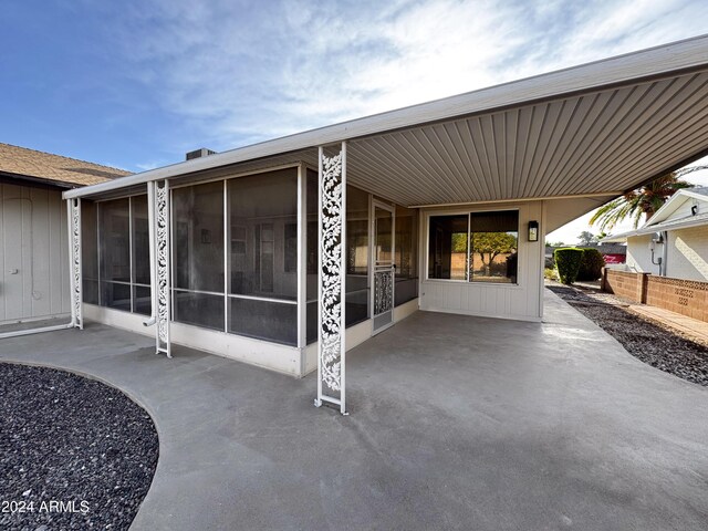 view of patio with a sunroom