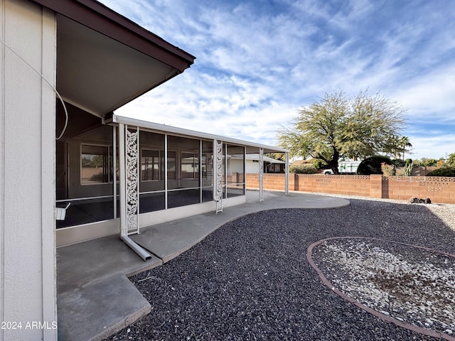 view of yard featuring a patio and a sunroom