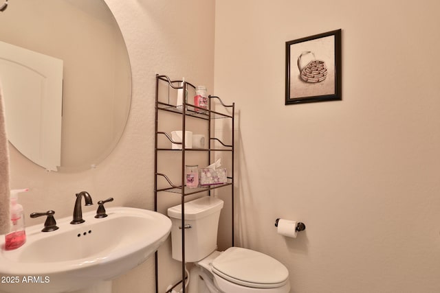 bathroom featuring sink and toilet