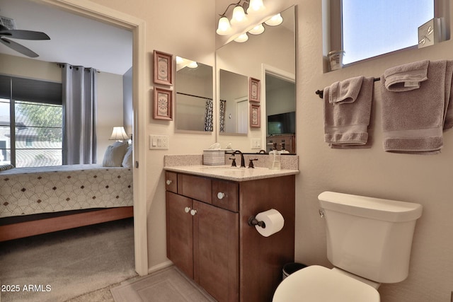 bathroom featuring vanity, ceiling fan, and toilet