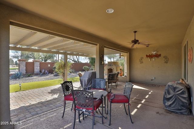 view of patio with an outdoor fireplace, a grill, and ceiling fan