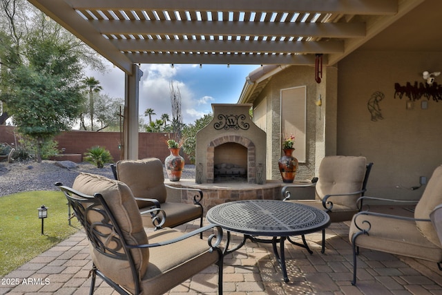 view of patio featuring exterior fireplace and a pergola