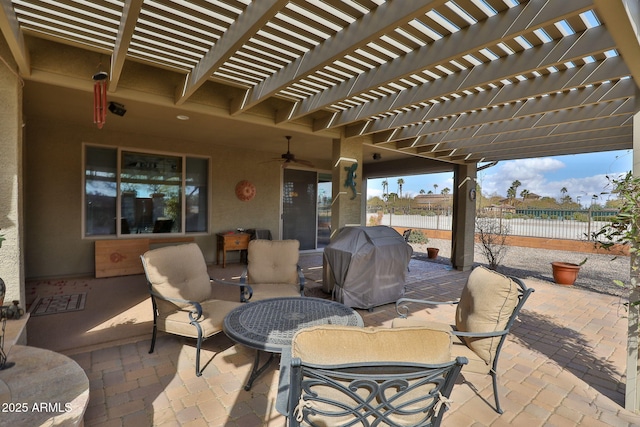 view of patio featuring area for grilling, ceiling fan, and a pergola