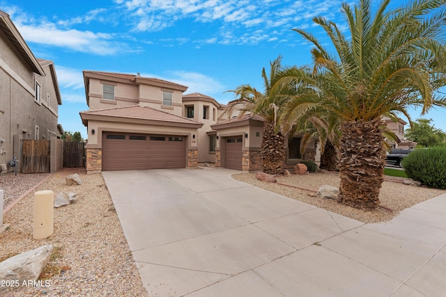 44348 W Windrose Dr, Maricopa, AZ 85138 - mediterranean / spanish home featuring stone siding, stucco siding, a garage, concrete driveway, and a tiled roof