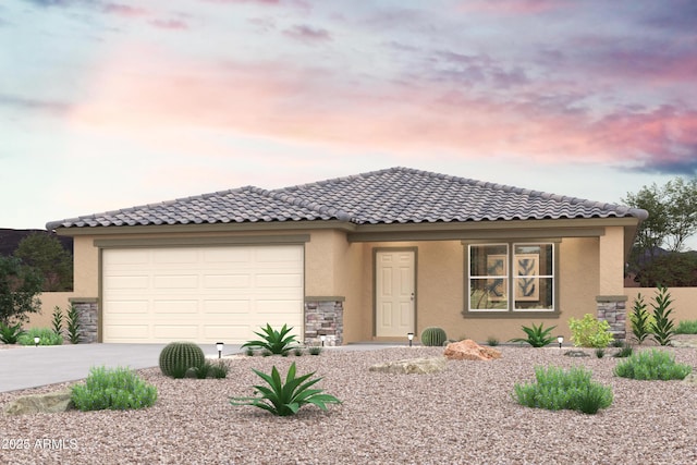 view of front of home featuring a tile roof, stucco siding, a garage, stone siding, and driveway