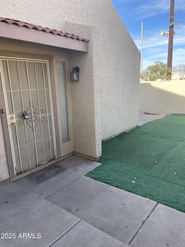 entrance to property with a patio area