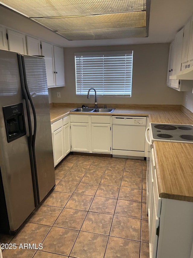 kitchen with sink, white cabinetry, stainless steel fridge with ice dispenser, white dishwasher, and dark tile patterned floors