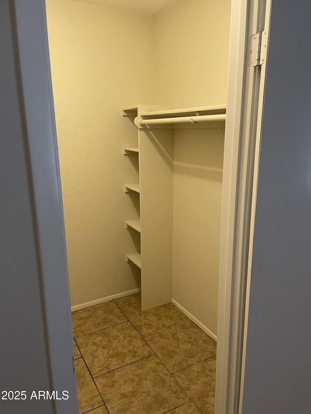 walk in closet featuring tile patterned flooring