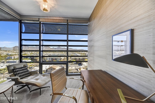 sunroom with a wealth of natural light and a mountain view