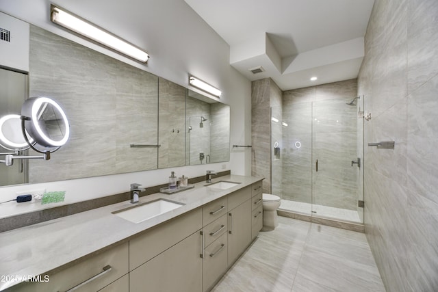 bathroom with walk in shower, vanity, tile patterned flooring, and toilet