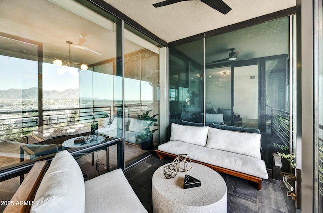 balcony featuring ceiling fan and a mountain view