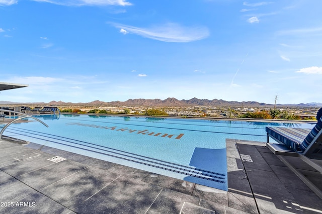 view of pool with a water and mountain view