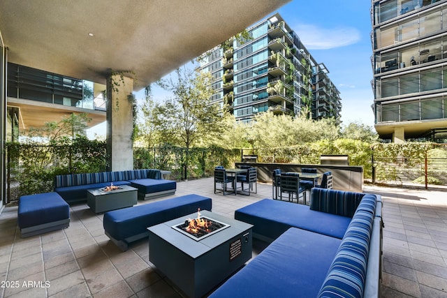 view of patio featuring an outdoor living space with a fire pit