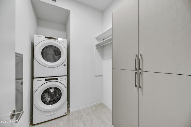 laundry area featuring stacked washer and dryer