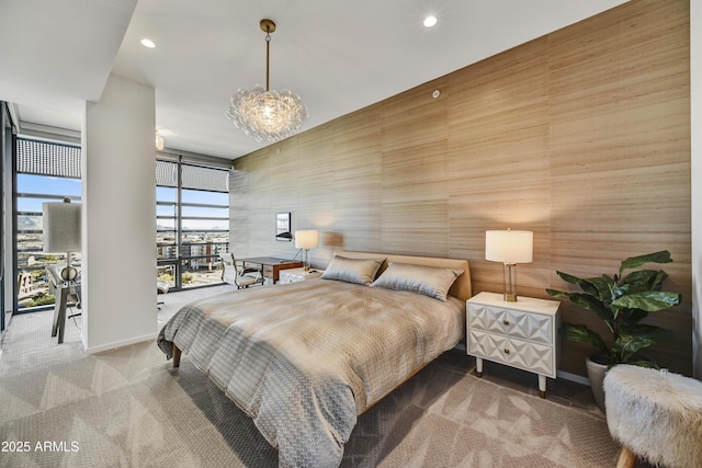 carpeted bedroom with a wall of windows and wooden walls