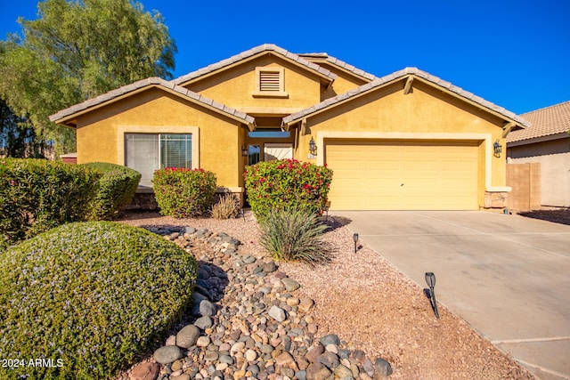 ranch-style home featuring a garage