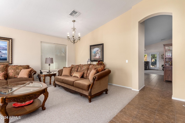 tiled living room featuring a chandelier and vaulted ceiling