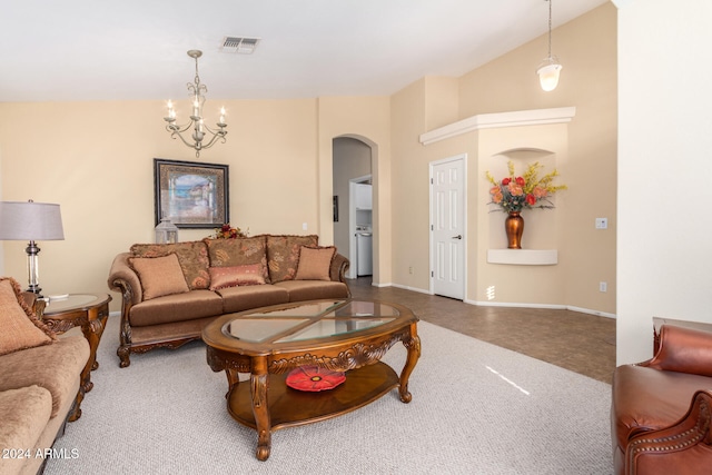 living room featuring a chandelier and lofted ceiling