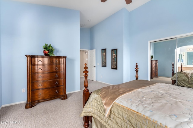 carpeted bedroom with ceiling fan and high vaulted ceiling