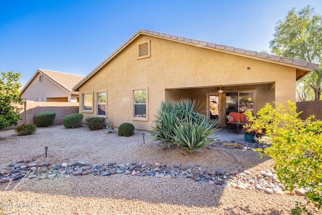 back of house featuring ceiling fan and a patio area