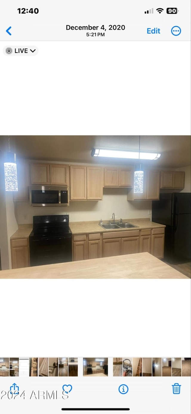 kitchen featuring sink and black appliances