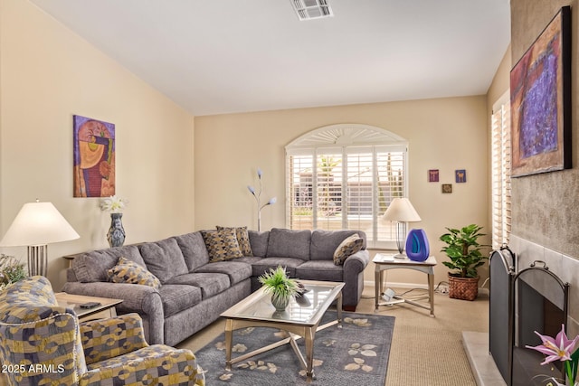 living area featuring carpet flooring and visible vents