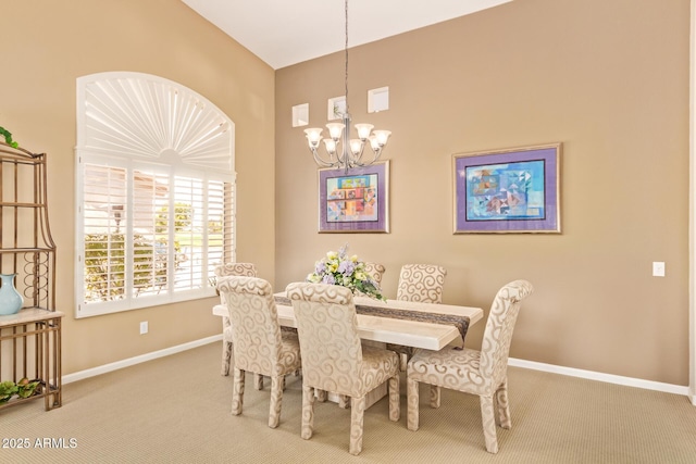 carpeted dining room with a chandelier and baseboards
