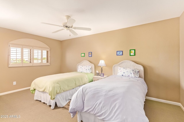 carpeted bedroom with ceiling fan and baseboards