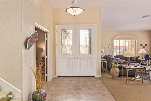entrance foyer with baseboards, visible vents, and french doors