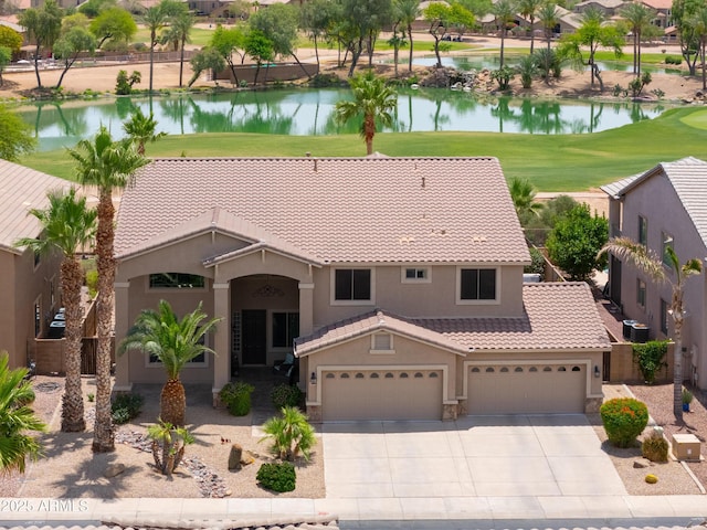 21841 N Ingram Ct, Maricopa, AZ 85138 - mediterranean / spanish-style home featuring stucco siding, a tile roof, a water view, and driveway