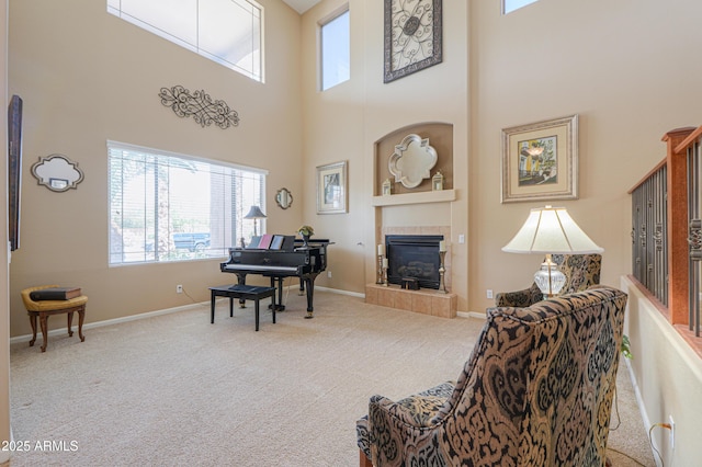 21841 N Ingram Ct, Maricopa, AZ 85138 - carpeted living area featuring a high ceiling, a fireplace, baseboards, and built in features