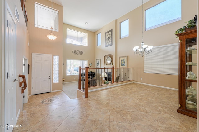 21841 N Ingram Ct, Maricopa, AZ 85138 - entrance foyer with light tile patterned flooring, plenty of natural light, a towering ceiling, a chandelier, and baseboards