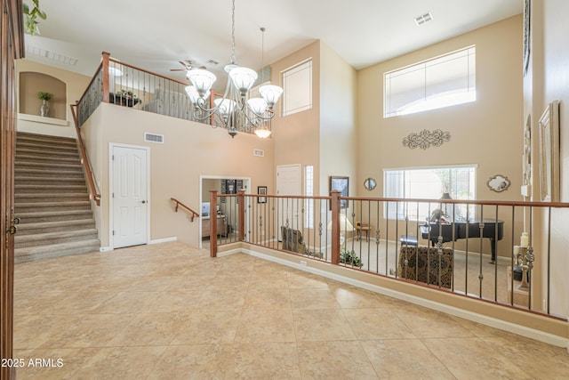 21841 N Ingram Ct, Maricopa, AZ 85138 - entrance foyer with a high ceiling, a chandelier, tile patterned flooring, and baseboards