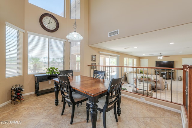 21841 N Ingram Ct, Maricopa, AZ 85138 - dining area with a towering ceiling, a ceiling fan, baseboards, and light tile patterned flooring