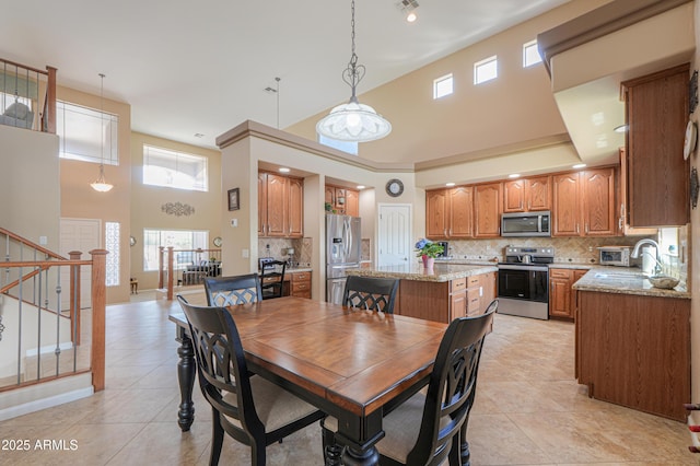 21841 N Ingram Ct, Maricopa, AZ 85138 - dining area with a high ceiling, light tile patterned flooring, stairs, and baseboards