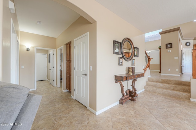 21841 N Ingram Ct, Maricopa, AZ 85138 - entrance foyer featuring light tile patterned floors, arched walkways, stairs, and baseboards
