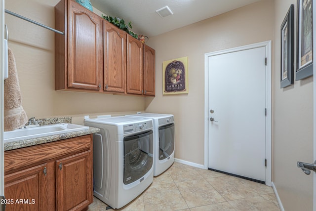 21841 N Ingram Ct, Maricopa, AZ 85138 - laundry room with washing machine and clothes dryer, cabinet space, baseboards, and light tile patterned flooring