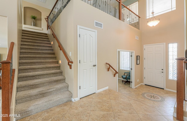 21841 N Ingram Ct, Maricopa, AZ 85138 - tiled entryway featuring stairway, baseboards, and a high ceiling