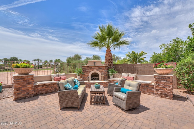 21841 N Ingram Ct, Maricopa, AZ 85138 - view of patio / terrace featuring an outdoor living space with a fireplace