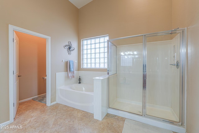 21841 N Ingram Ct, Maricopa, AZ 85138 - bathroom with a garden tub, a shower stall, a towering ceiling, tile patterned flooring, and baseboards