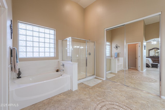 21841 N Ingram Ct, Maricopa, AZ 85138 - ensuite bathroom featuring a bath, a high ceiling, a shower stall, and baseboards