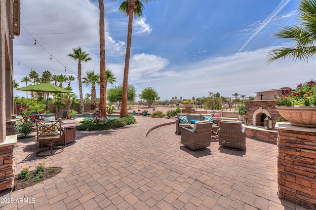 21841 N Ingram Ct, Maricopa, AZ 85138 - view of patio / terrace with an outdoor fireplace and an outdoor pool